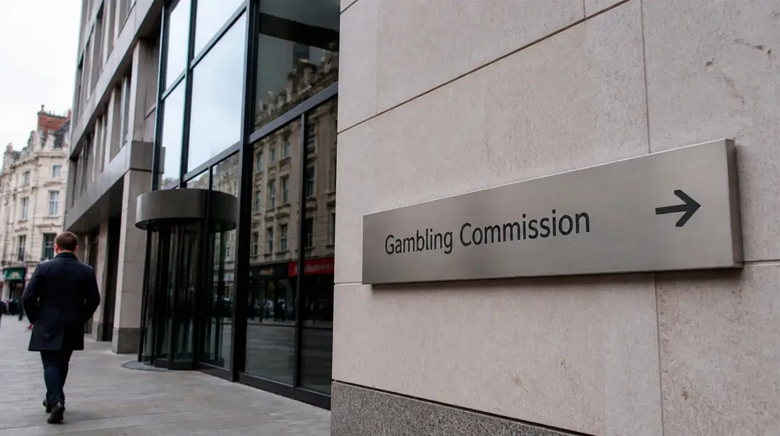 Editorial photograph of the UK Gambling Commission building exterior with directional signage
